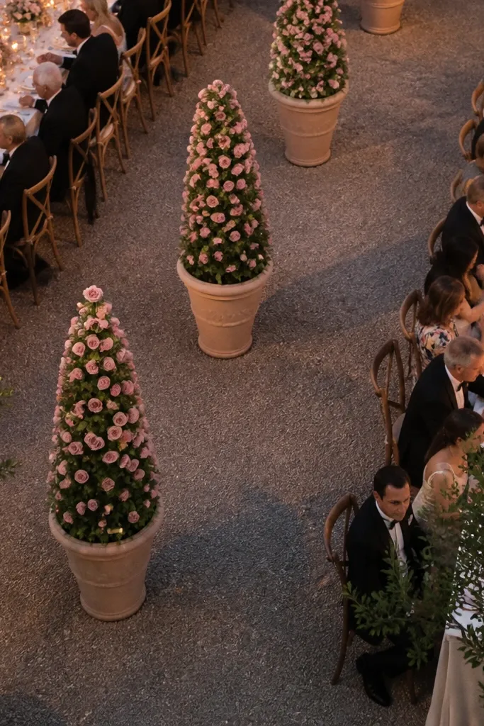 Two matte urns with cone-shaped mini rose arrangements on a table