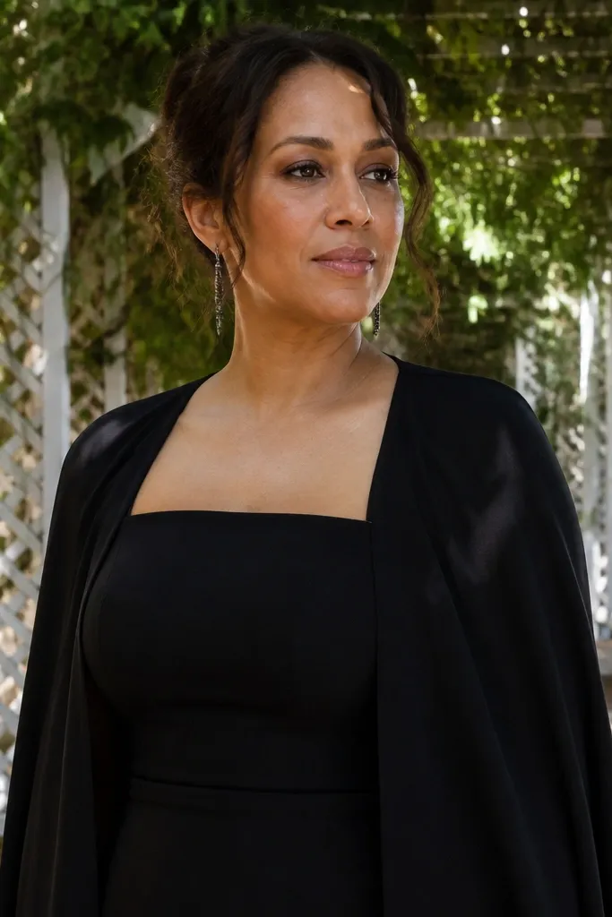 Black crepe strapless dress with a detachable draped cape overlay